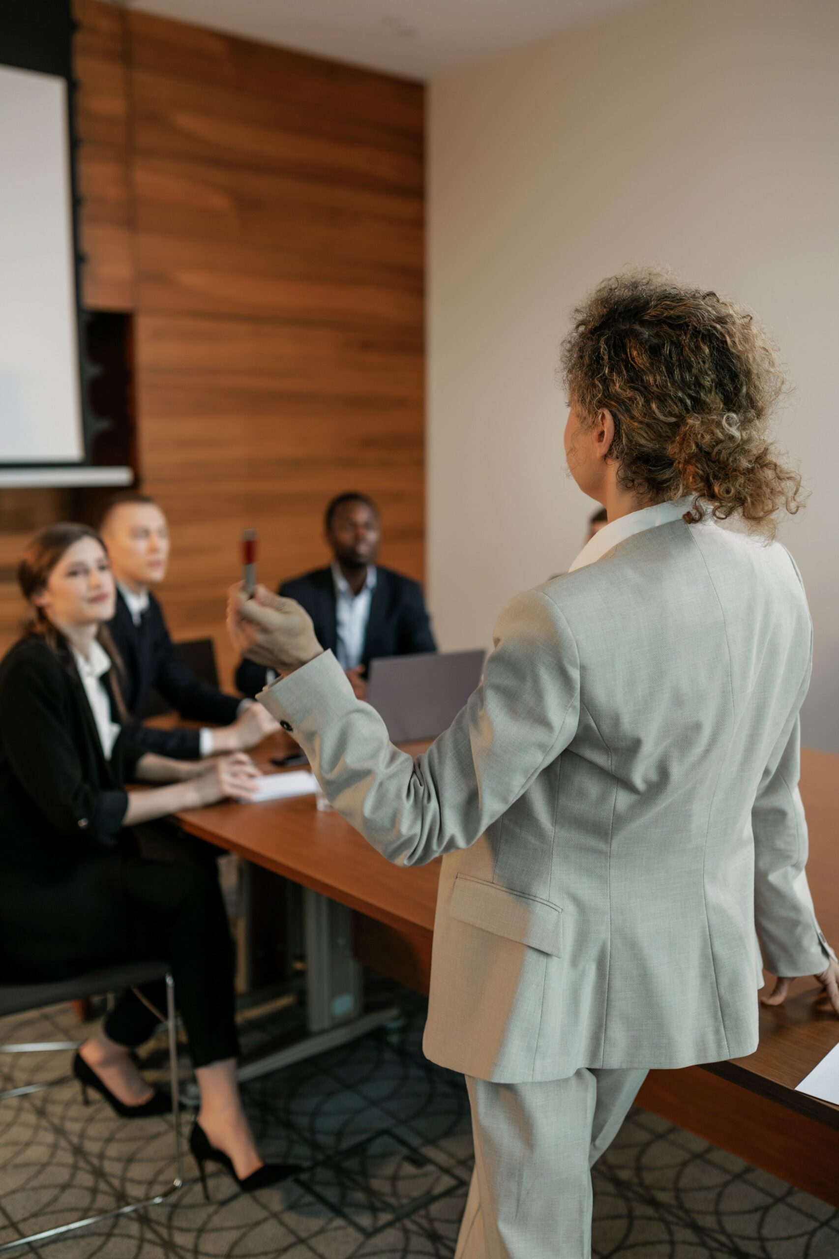 Business professionals in a meeting room discussing corporate strategies.